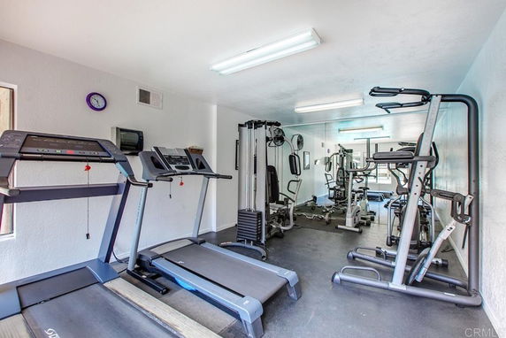 Exercise room with treadmills and gym equipment.