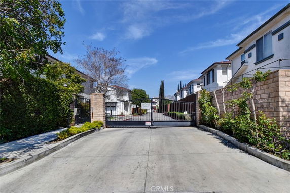 Front view of a gated residential area with multiple houses.