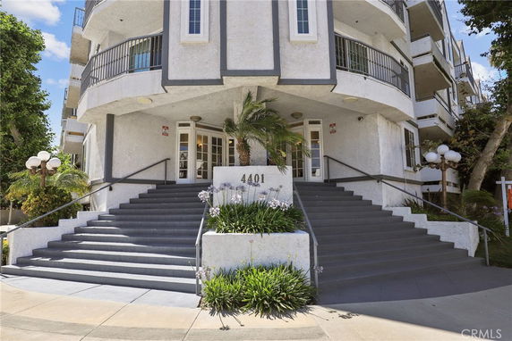 Front view of a multi-story building with staircases and balconies.