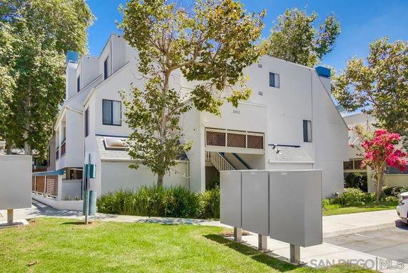 Front view of a multi-story residential building with a modern design and multiple windows.