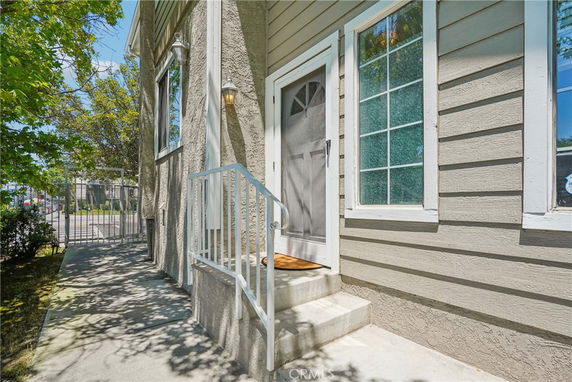 Front view of a house with a small entryway and a side window.