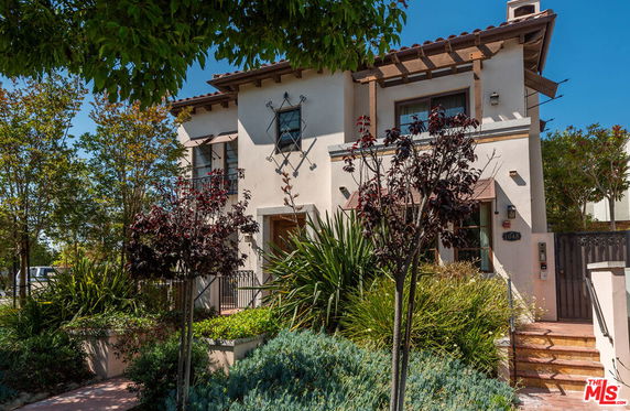 Front view of a two-story house with a gated entrance