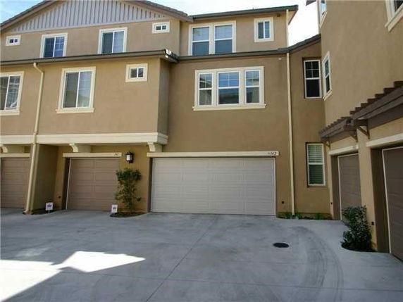 Front view of a multi-story residential building with garages.