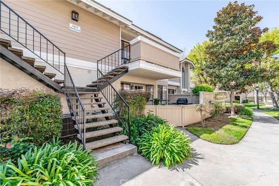 Front view of a multi-unit residential building with exterior stairs.