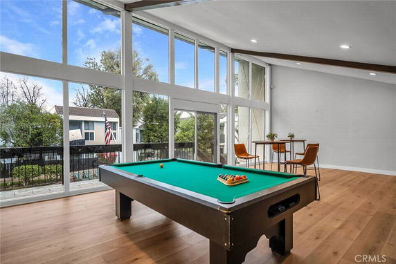 Interior view of a room with a large pool table and seating area.