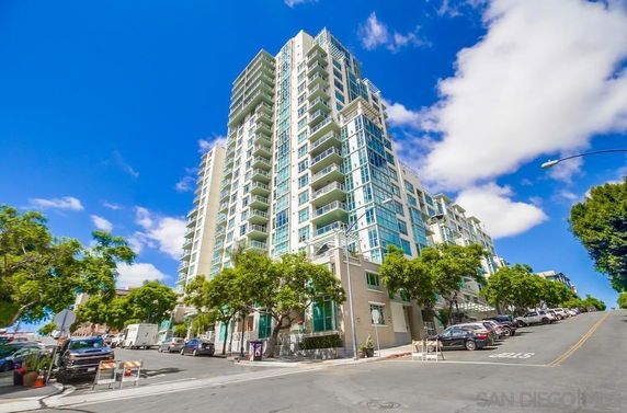 Front view of a high-rise residential building with multiple balconies.