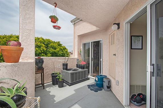 Rooftop area with potted plants and utility equipment.