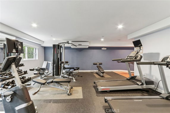 Indoor gym with exercise equipment including treadmills and weight machines.