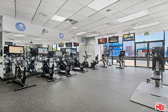 Indoor gym area with exercise bikes and fitness equipment.