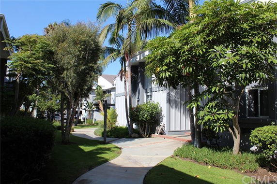 Front view of a house with a walkway and trees.