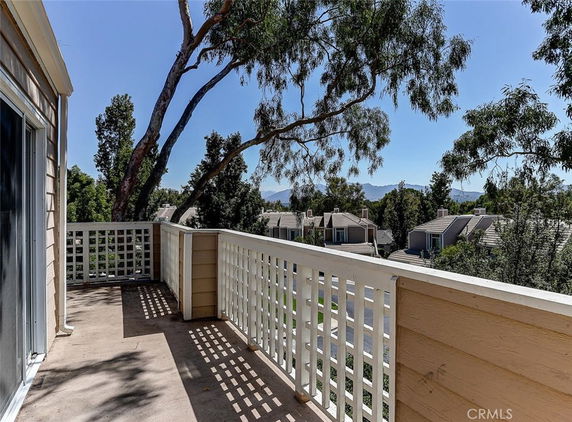 Patio view overlooking residential area with mountains in the background.