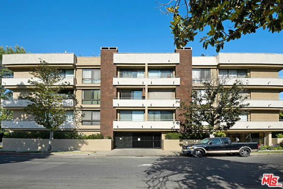 Front view of a multi-story residential building with balconies.