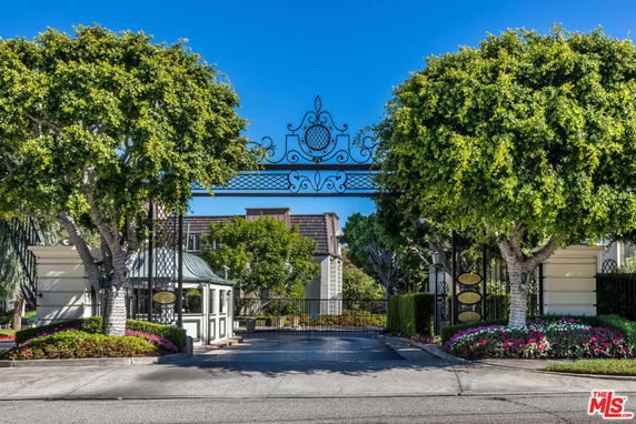 Front view of a gated entrance structure with decorative metalwork.