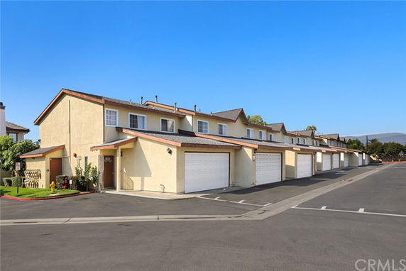 Front view of a two-story townhouse complex with garages.