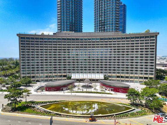 Front view of a large multi-story building with two high-rise towers.