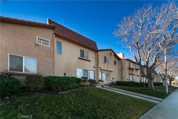 Front view of a multi-story residential building with multiple units.