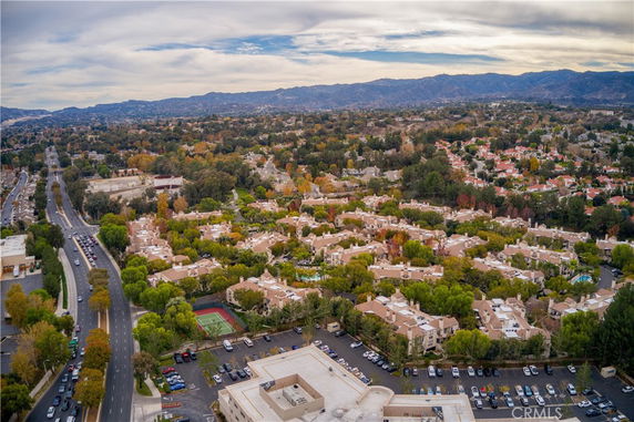 Panoramic view of a sprawling residential area with surrounding roads and greenery.