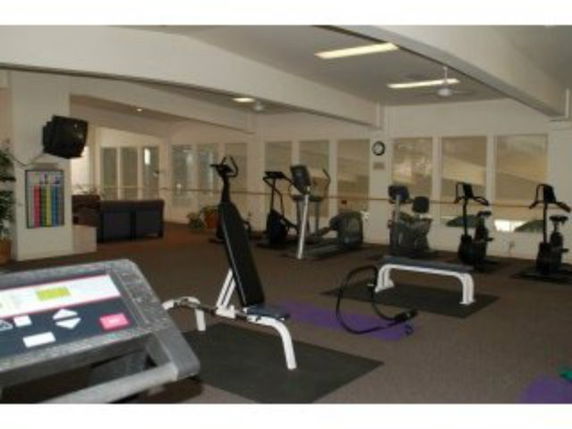 Interior view of a gym area with exercise equipment.