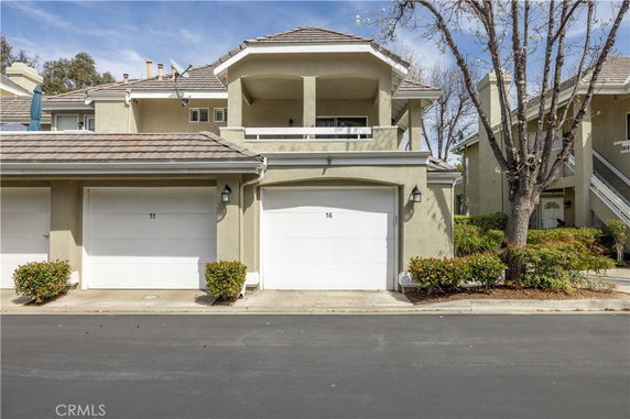Front view of a two-story residential building with garages.