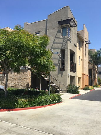 Front view of a modern multi-story building with external staircases.