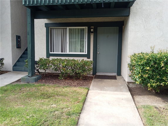 Front view of a house with entryway and window.