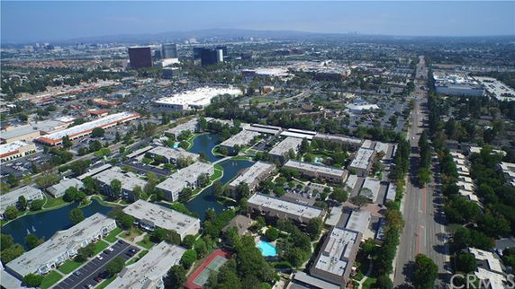 Panoramic view of a residential area with multiple buildings and surrounding landscape.