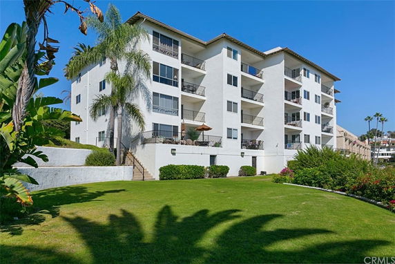 Front view of a multi-story apartment building with balconies.