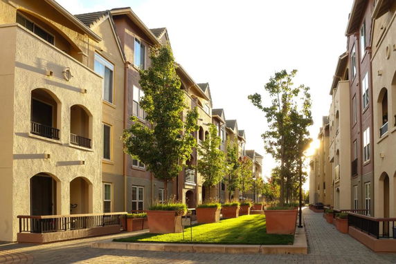 Front view of multi-story apartment buildings with balconies.