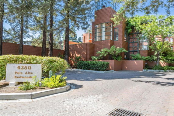 Front view of a modern building with brick exterior and large windows.