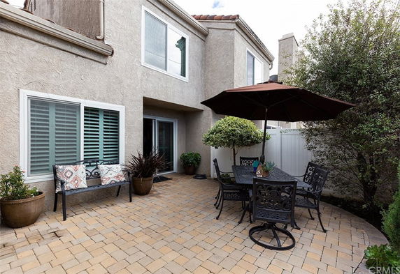 Front view of a house with a small outdoor patio area.
