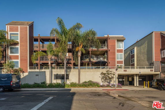 Front view of a multi-story residential building with balconies.