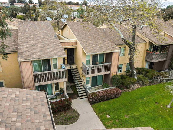 Front view of a two-story apartment building with balconies.