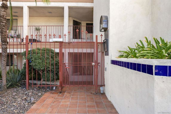 Entrance to a building with a gated entryway and plants.