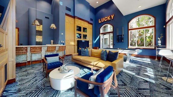 Interior of a club house with a seating area and bar.