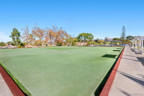 Outdoor sports field with green turf and surrounding pathway.