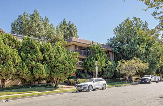 Front view of a multi-story residential building with balconies.
