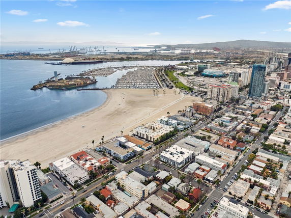 Panoramic view of a coastal city with beach and buildings.