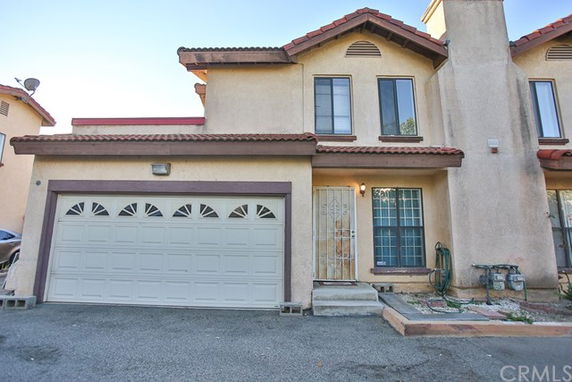Front view of a two-story house with a garage.