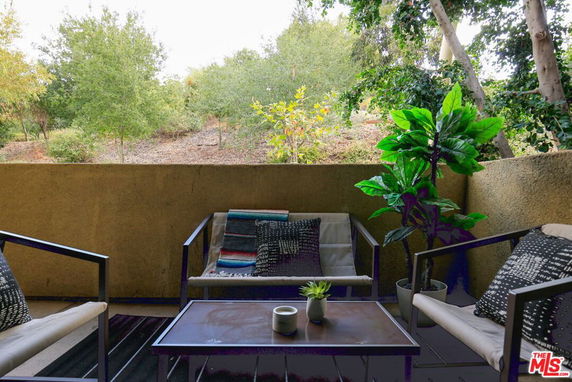 Outdoor seating area with views of surrounding greenery.