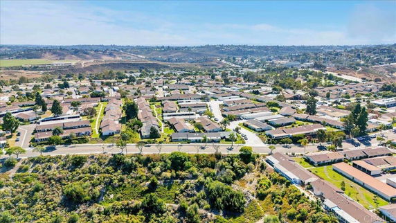 Panoramic view of a residential area with rows of houses and surrounding landscape.