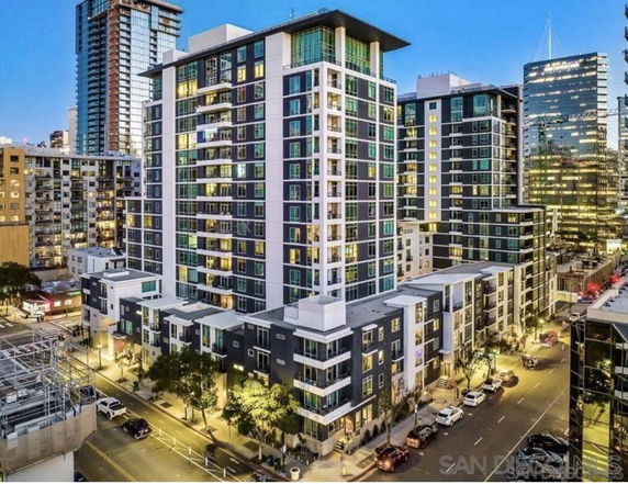 Front view of a modern multi-story apartment building in an urban setting.