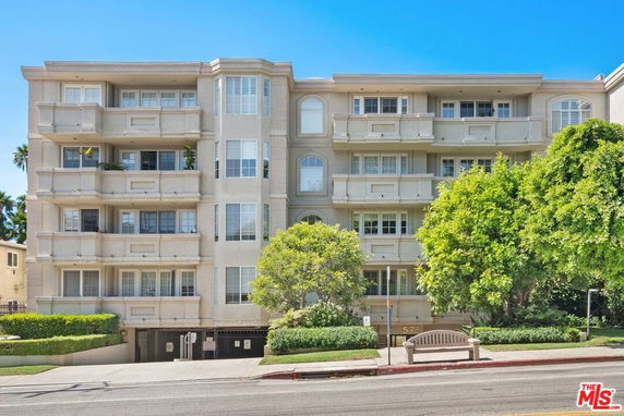 Front view of a multi-story residential building with balconies.