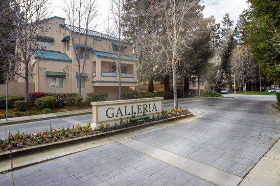 Front view of a multi-story residential building with a sign labeled 'Galleria'.