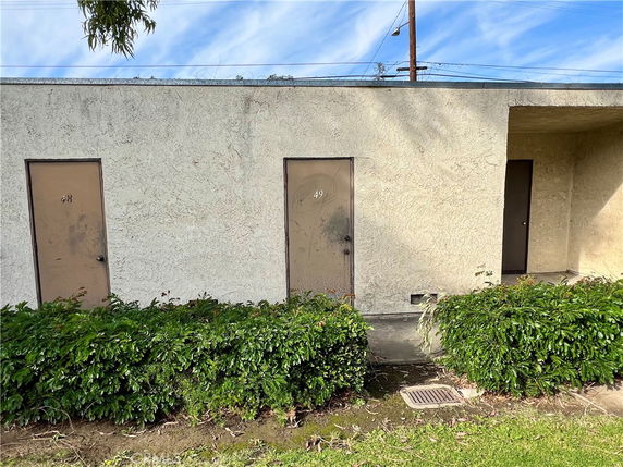Front view of a building with two doors numbered 48 and 49.