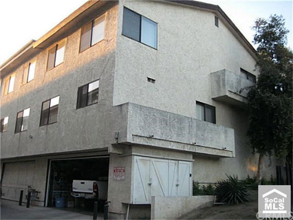 Front view of a multi-story residential building with a garage.