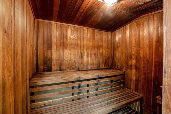 Wooden sauna room with benches.
