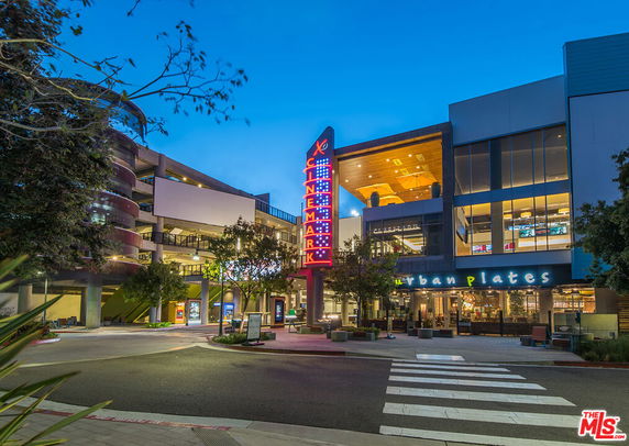 Front view of a commercial building with a cinema and restaurant.