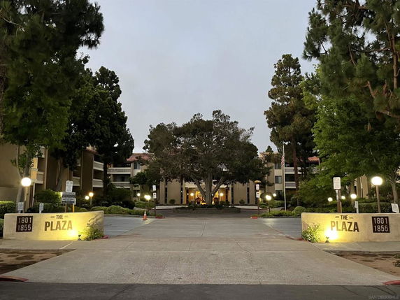 Front view of a multi-story apartment complex with entrance signage reading 'The Plaza 1801-1855'.