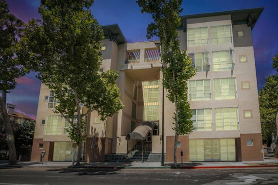 Front view of a multi-story building with a central entrance canopy.