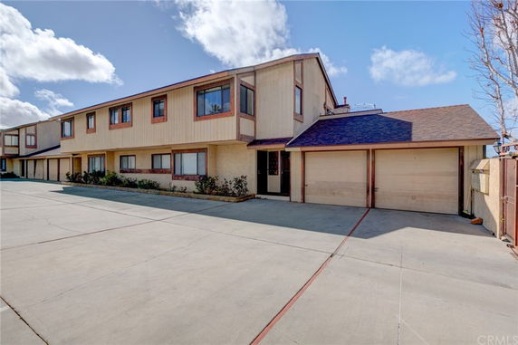 Front view of a two-story building with a double garage.